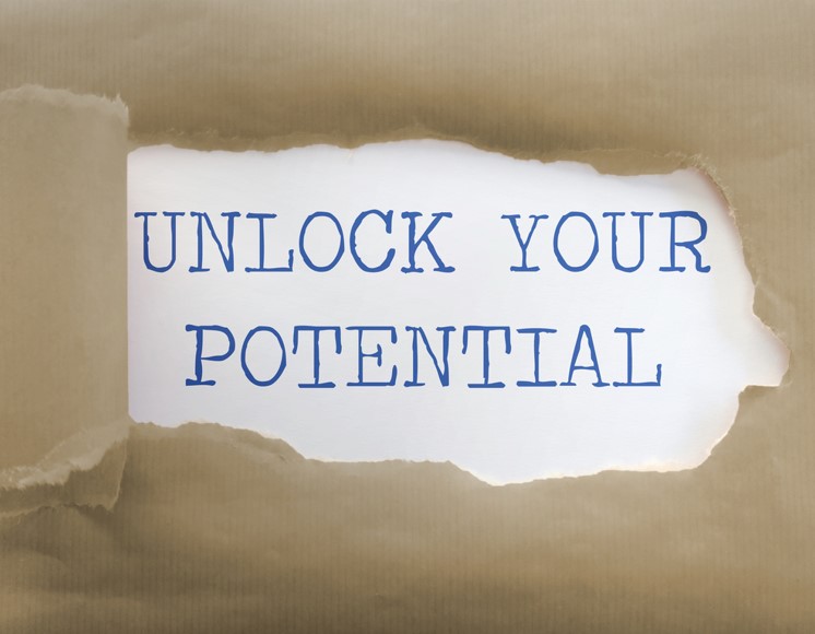 a white box wrapped in brown parcel paper. The brown paper is peeled back to reveal text on the white box that reads "Unlock your potential". 