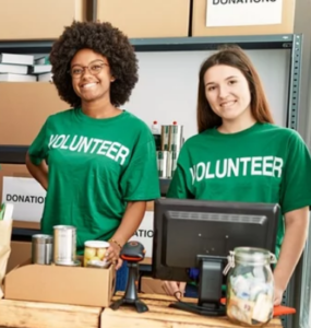 Two student volunteers in a charity.